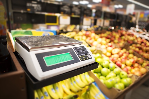 Retail Store Electronic Weighing Scales and the Store Fresh Products in the Background