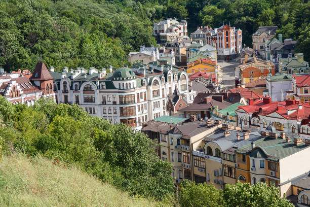 istock Multicolored houses surrounded by green trees. Kiev, Ukraine 843341574