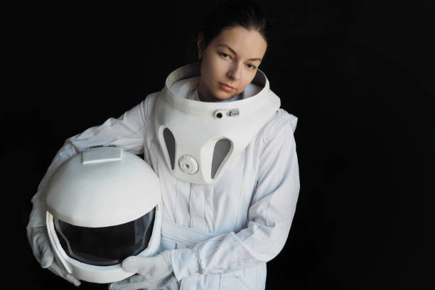 istock Female astronaut on a black background. Fantastic space suit. Exploration of outer space. 843342092