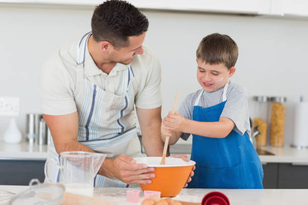 istock Father and son making cookies at counter 843345394