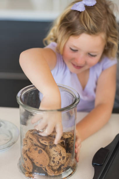 istock Girl reaching for cookies in jar 843345816
