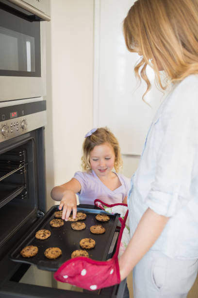 istock Mother and daughter baking cookies 843345946