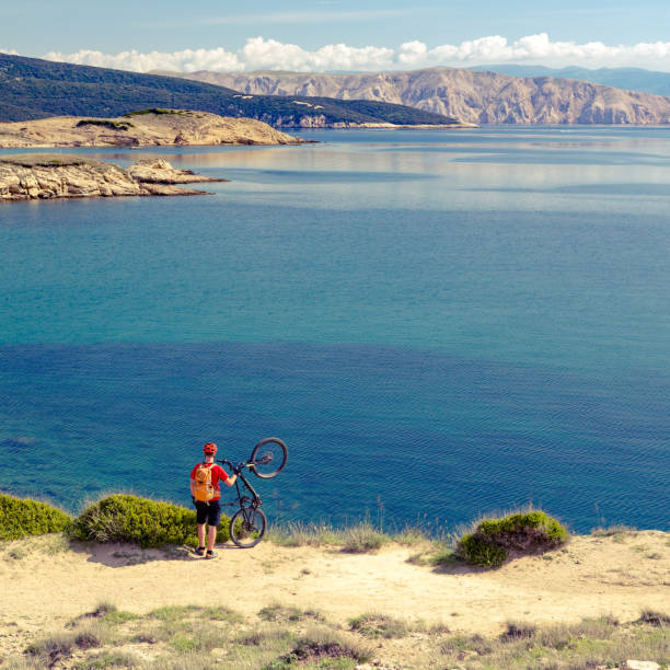 istock Mountain biker celebrating inspiring view at the sea 843348762