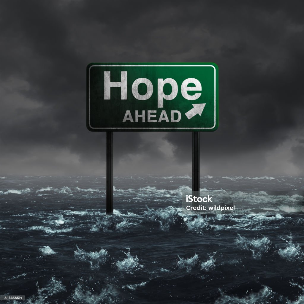 Hope Ahead Hope ahead inspirational and motivational life concept as a highway sign drowning in deep flood waters after a hurricane storm as a message of spiritual faith or the promise of recovery and patriotic unity with 3D illustration elements. Hurricane - Storm Stock Photo