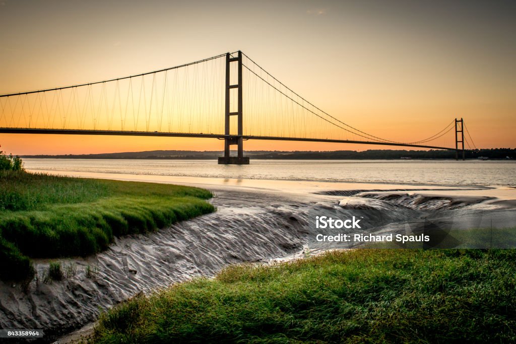 Humber bridge at low tide sunset over the river Humber Humber Bridge Stock Photo
