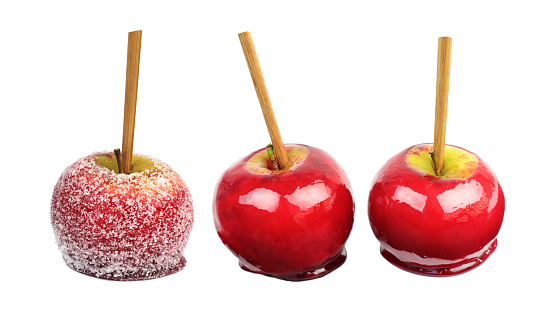 Red caramel  and sugar coated apples on  white background.