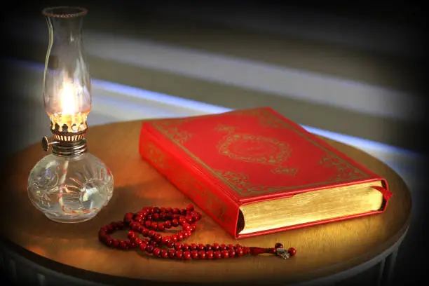 Photo of Quran, prayer beads beads and oil lamp. . Quran is holy book religion of Islam.