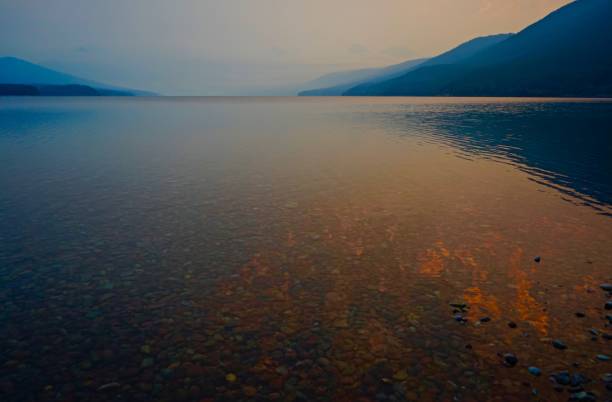 lake mcdonald fire water - montana mountain mcdonald lake us glacier national park imagens e fotografias de stock