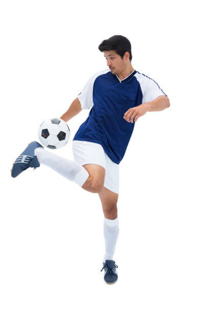 istock Football player in blue kicking ball 843375418