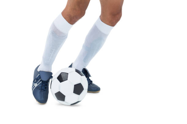 istock Football player kicking the ball 843375532