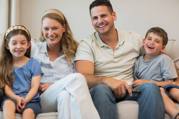istock Happy parents and children sitting on sofa 843378832