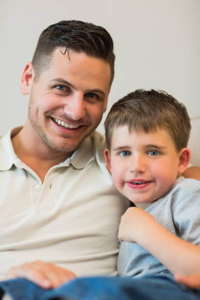 istock Father and son smiling together at home 843379216