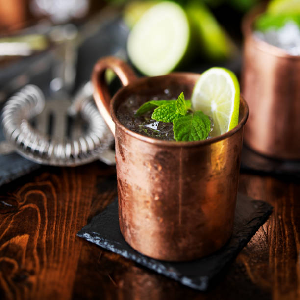 istock moscow mule cocktail in copper mug garnished with mint and lime 843379924