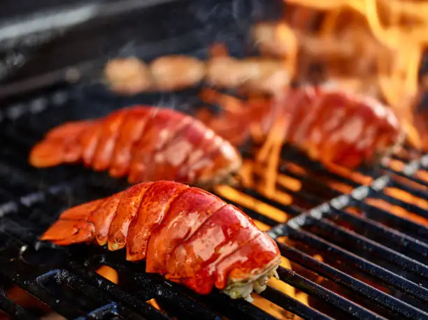 grilling lobster tails over hot flame