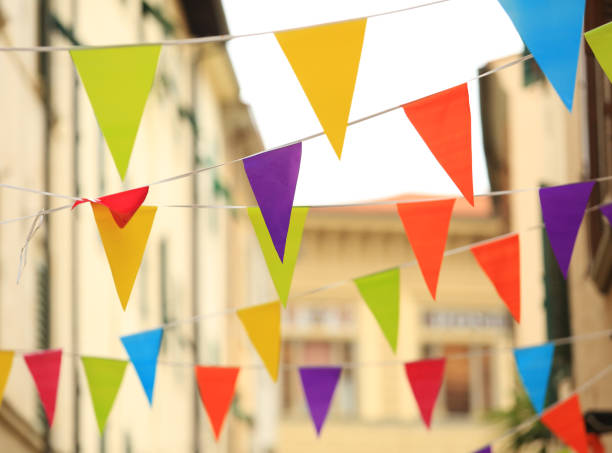 istock Colorful flag hanging on string in city 843392876
