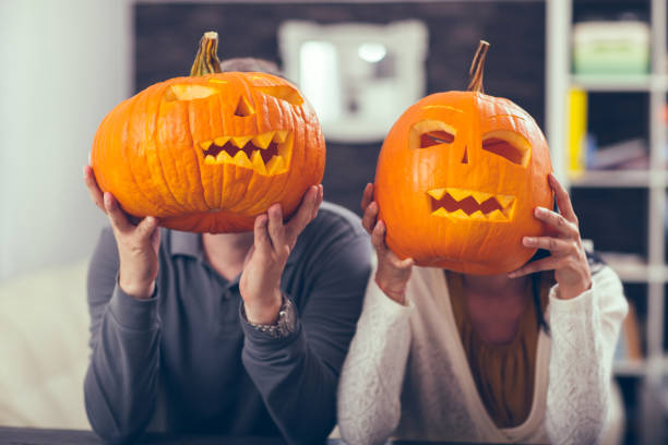 istock Man and woman having fun with Halloween pumpkin 843393990