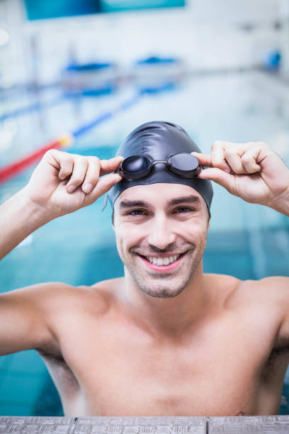 istock Handsome man wearing swim cap and goggles 843394516