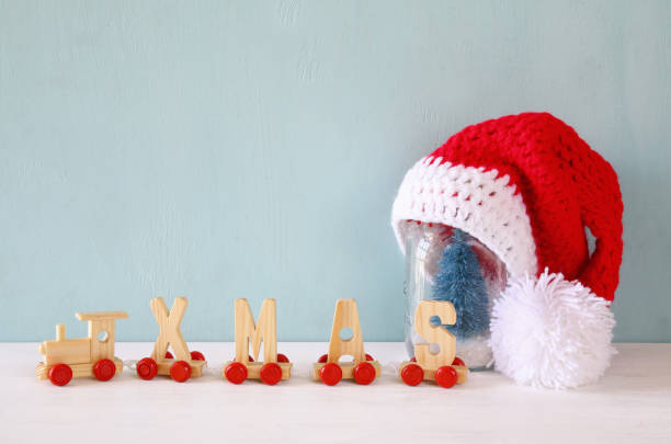 istock santa hat on mason jar with christmas tree 843396032