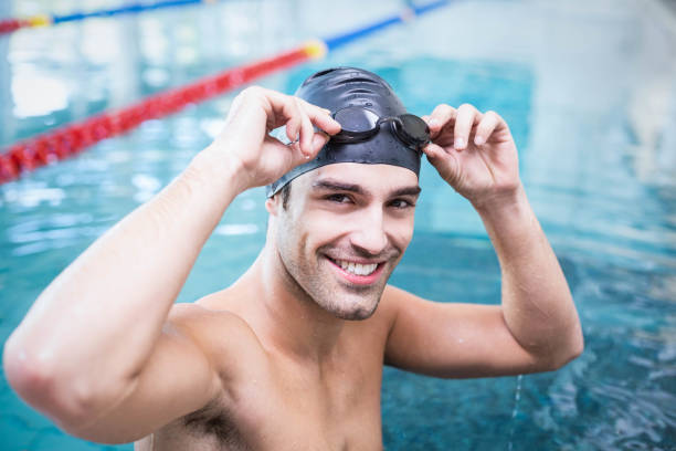 istock Handsome man wearing swim cap and goggles 843396730