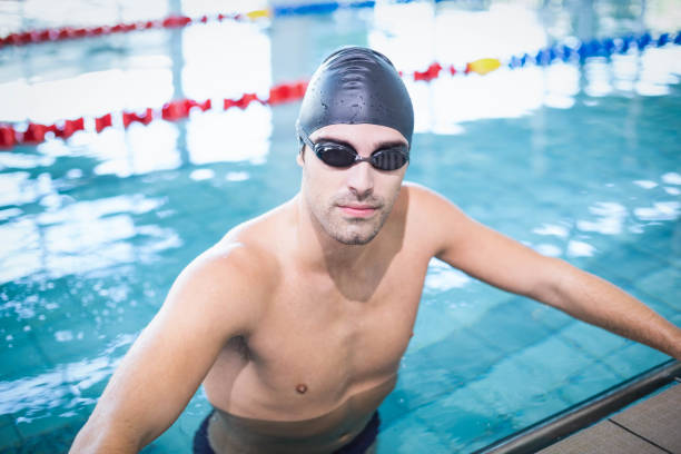 istock Handsome man wearing swim cap and goggles 843396766
