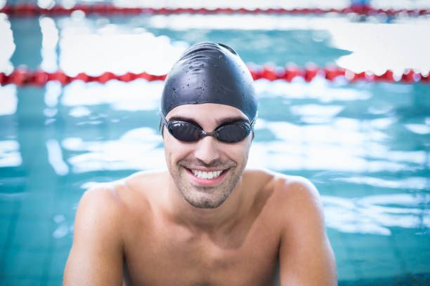 istock Handsome man wearing swim cap and goggles 843396794