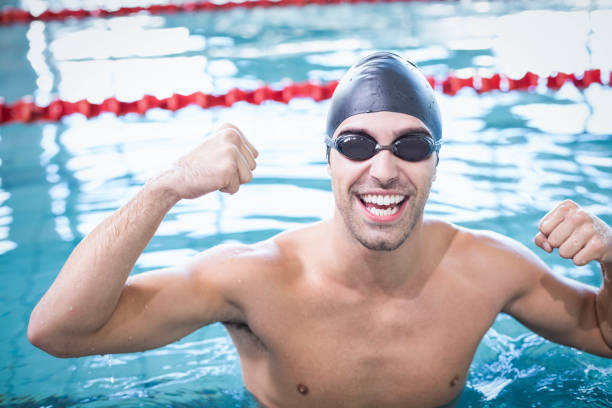 istock Handsome man wearing swim cap and goggles 843396812