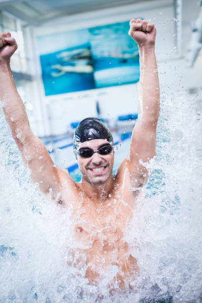 istock Handsome man triumphing in the water 843396880