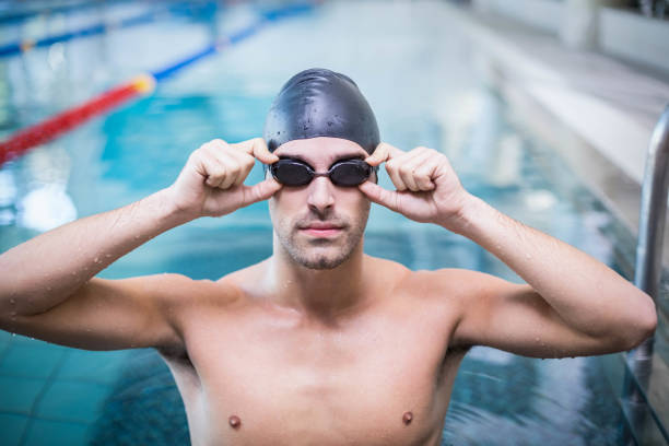 istock Handsome man wearing swim cap and goggles 843396936