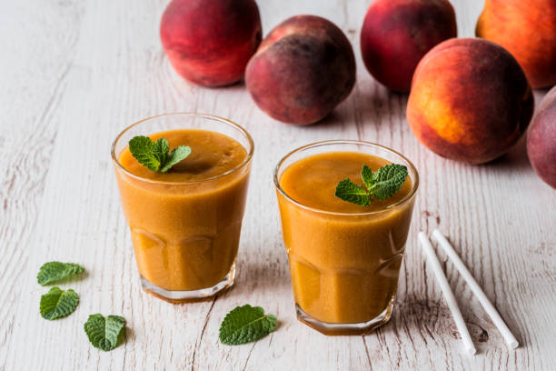 istock Healthy beverage - fresh blended peach smoothie with mint 843397600