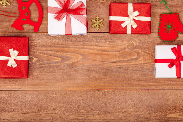 istock christmas background with decorations and gift boxes on wooden table, top view, copyspace 843400328