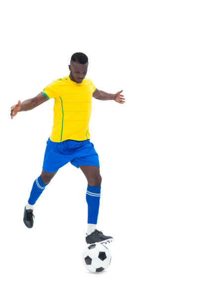 istock Football player in yellow kicking ball 843404332