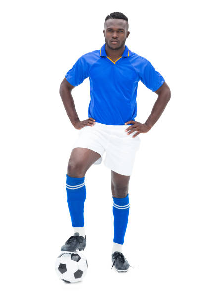 istock Football player in blue standing with the ball 843404520