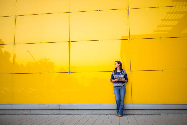 istock Lady by the yellow wall 843408540
