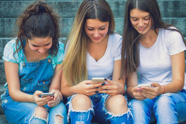 istock Three Teenage Girls Using Their Smartphones 843411236