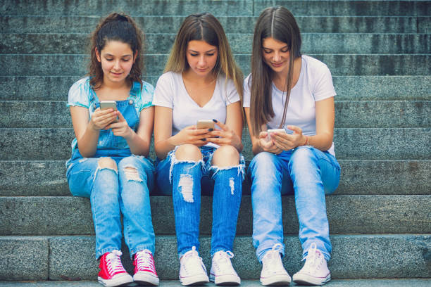 istock Three Teenage Girls Using Their Smartphones 843411600