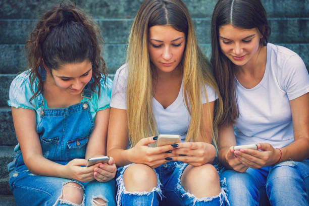 istock Three Teenage Girls Using Their Smartphones 843411610