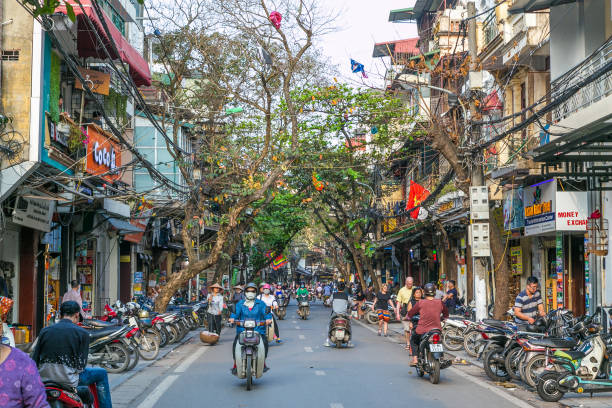 Old Quarter Hanoi Hanoi: Streets of the Old Quarter of Hanoi during the day. Lots of people and traffic can be seen. hanoi stock pictures, royalty-free photos & images