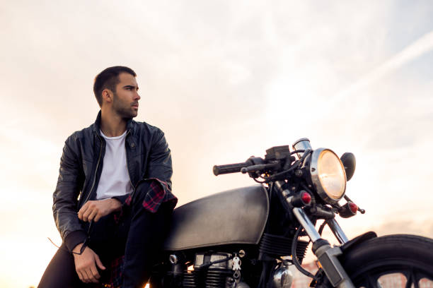 istock Brutal man sit on cafe racer custom motorbike. 843414510