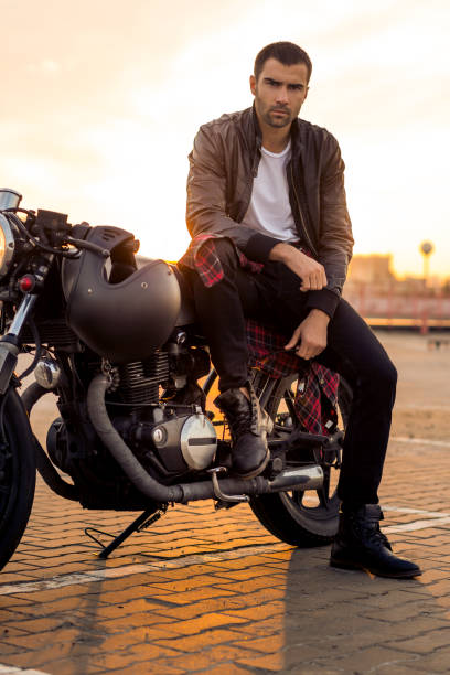 istock Brutal man sit on cafe racer custom motorbike. 843414770