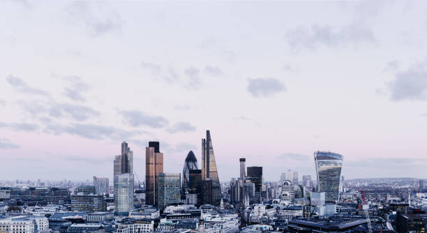 City Of London Skyline City Of London skyline at sunset, with cloudy sky canary wharf photos stock pictures, royalty-free photos & images