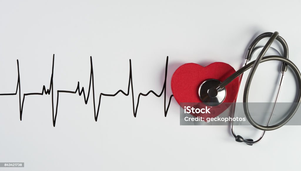 Medical stethoscope and red heart with cardiogram Medical stethoscope and red heart with cardiogram isolated on white. Cardiac therapeutics assistance, pulse beat measure document, arrhythmia pacemaker medical healthcare concept Heart Attack Stock Photo