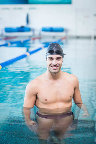 istock Handsome man wearing swim cap and goggles 843424138