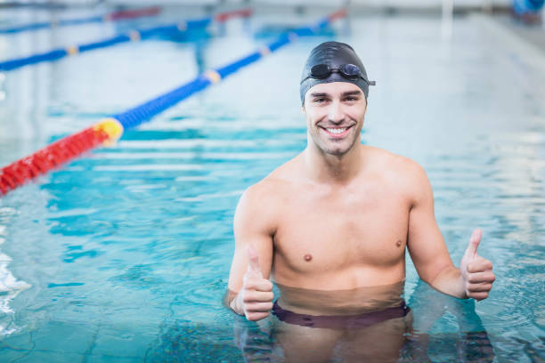 istock Handsome man with thumbs up in the water 843424150