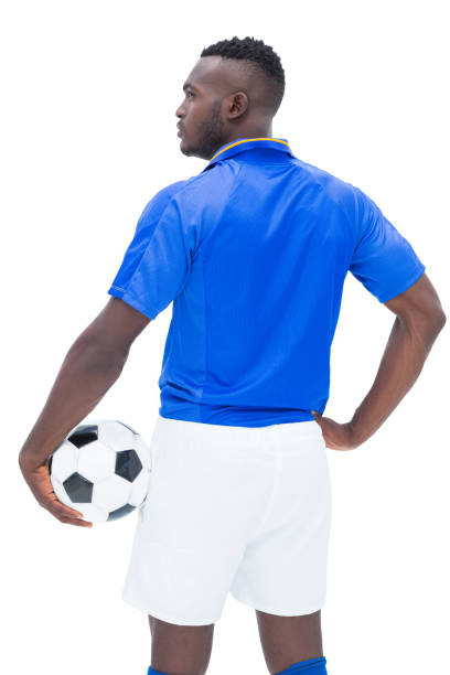 istock Football player in blue standing with the ball 843425236