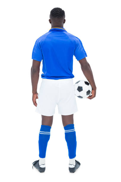 istock Football player in blue standing with the ball 843425272