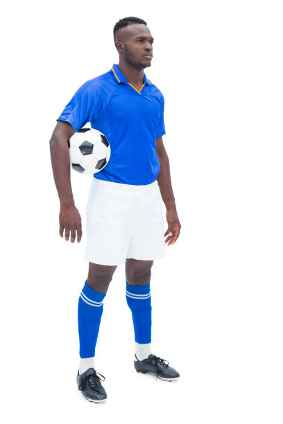 istock Football player in blue standing with the ball 843425316
