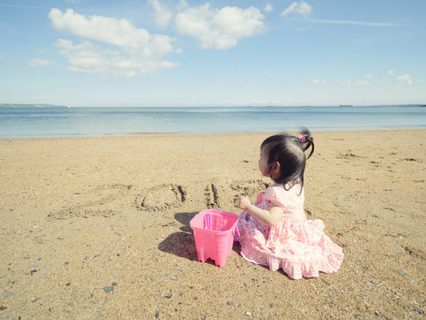 baby girl playing in sandy beach,Northern Ireland