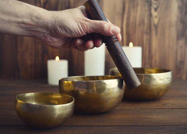 istock Male playing on Tibetan singing bowls 843435550