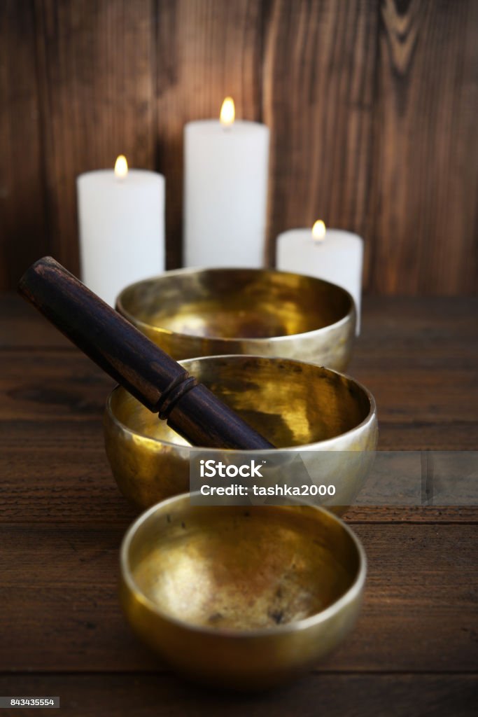 Tibetan handcrafted singing bowls Tibetan handcrafted singing bowls with sticks on wooden background Arts Culture and Entertainment Stock Photo