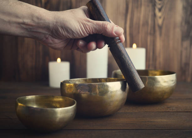 istock Male playing on Tibetan singing bowls 843435564